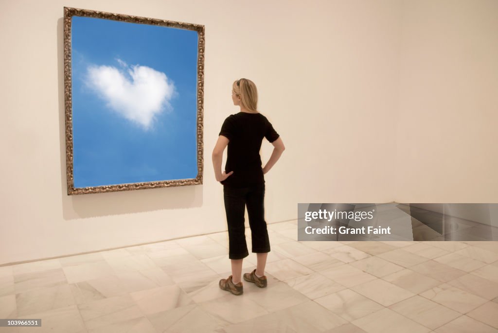 Young woman looking at framed photograph