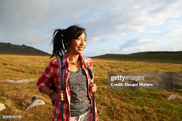 happy positive asian woman hiker smiling on rural moorland. - southeast asian ethnicity stock pictures, royalty-free photos & images