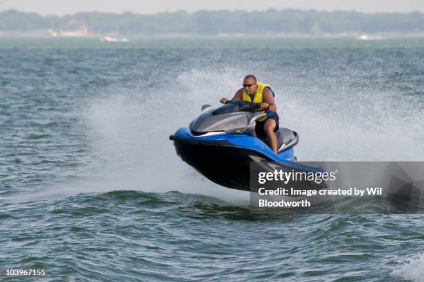 man on flying watercraft - jet boat stock pictures, royalty-free photos & images