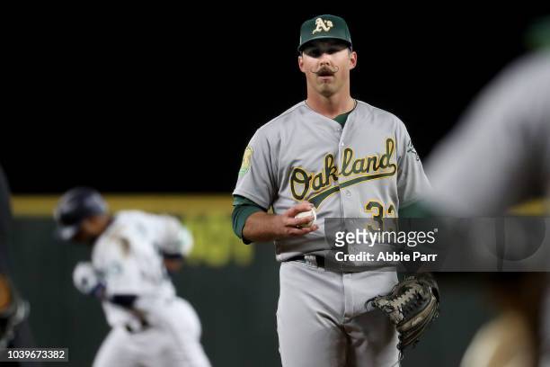 Daniel Mengden of the Oakland Athletics reacts after giving up a solo home run to Robinson Cano of the Seattle Mariners in the first inning during...