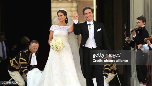 Swedish Princess Madeleine and her husband Chris O'Neill leave the Chapel of the Royal Palace in Stockholm, Sweden, after their wedding 08 June 2013....