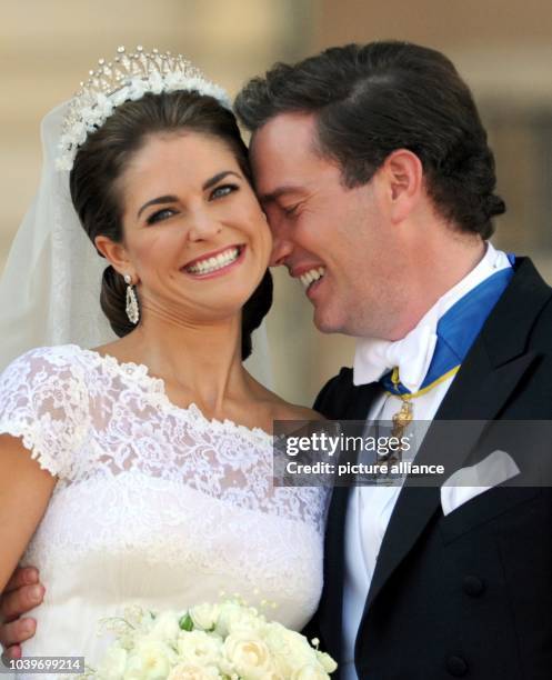 Swedish Princess Madeleine and her husband Chris O'Neill leave the Chapel of the Royal Palace in Stockholm, Sweden, after their wedding 08 June 2013....