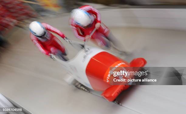 Swiss bobbers Caroline Spahni and her brakewoman Ariane Walser start a run at the women's two-person bobsleigh world cup at the artificial ice track...