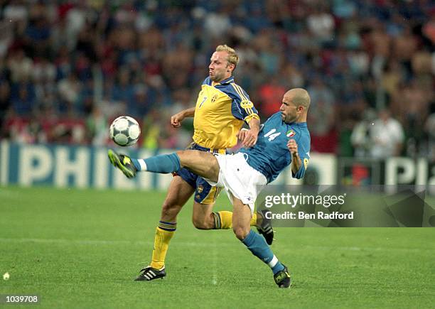 Luigi Di Biagio of Italy tackles Hakan Mild of Sweden during the European Championships 2000 group match at the Philips Stadium in Eindhoven,...