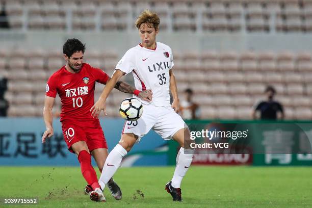 Jung Seung-Hyun of Kashima Antlers and Alexandre Pato of Tianjin Quanjian compete for the ball during the AFC Champions League quarterfinal 2nd leg...