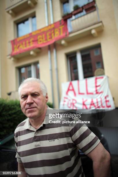 Tenant Kalle Gerigk stands in his street in front of banners of his supporters reading 'Our neighbor Kalle stays' and 'All for Kalle' in Cologne,...
