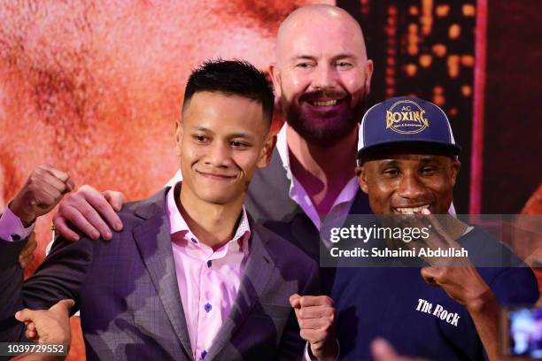 Paulus Ambunda of Namibia and Muhamad Ridhwan of Singapore pose for a photo as founder and CEO of Ringstar, Scott Patrick Farrell looks on during the...