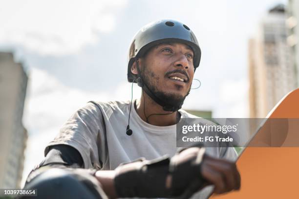 skateboarding man lifestyle portrait in the street - man wearing helmet stock pictures, royalty-free photos & images