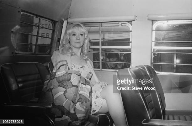 English former singer Janie Jones pictured seated in the back of a prison van in England on 13th July 1973.