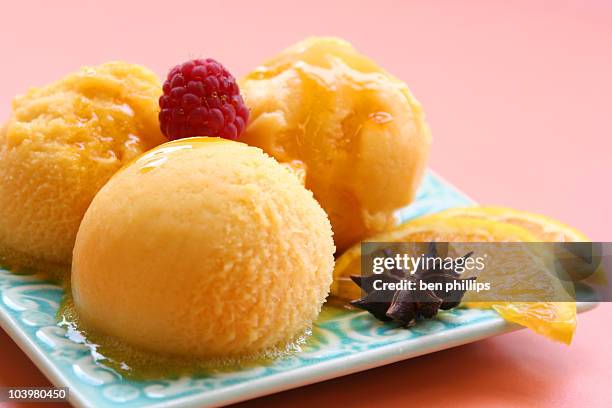orange sorbet served on a plate with slices of orange - fruit sorbet stock pictures, royalty-free photos & images