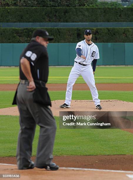 Major League umpire Jim Joyce looks on as Armando Galarraga of the Detroit Tigers throws a warm-up pitch before the start of the game against the...