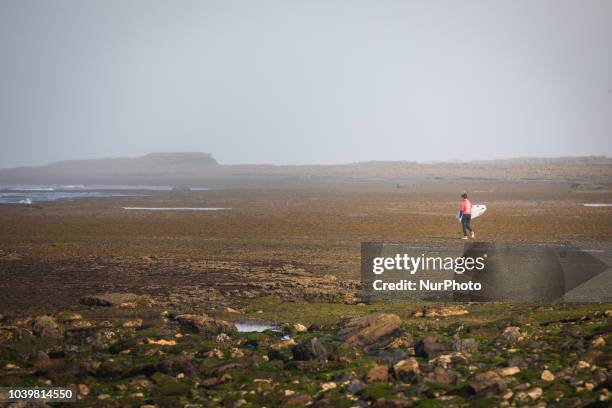 Australian surfer Jared Hickel walks on the rocks during the empty tide to reach the waves. Some of the best surfers in the world have arrived in...