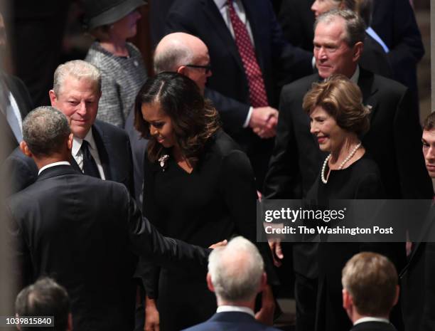 Former Presidents Barach Obama and George Bush with their wives Michelle and Laura talks with former VP Al Gore at the funeral service at the...