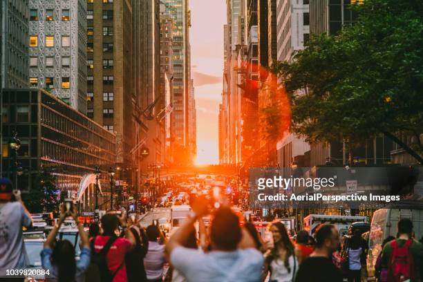 the manhattan henge - photographing sunset stock pictures, royalty-free photos & images