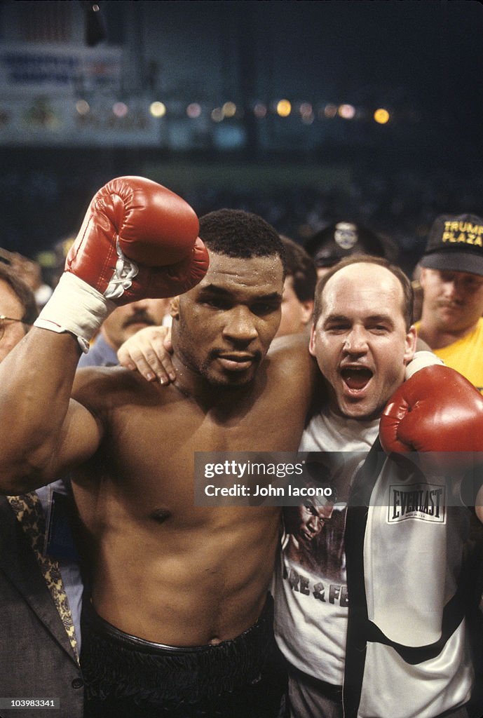 Mike Tyson Victorious With Trainer Kevin Rooney After Winning Fight mike-tyson-victorious-with-trainer-kevin-rooney-after-winning-fight