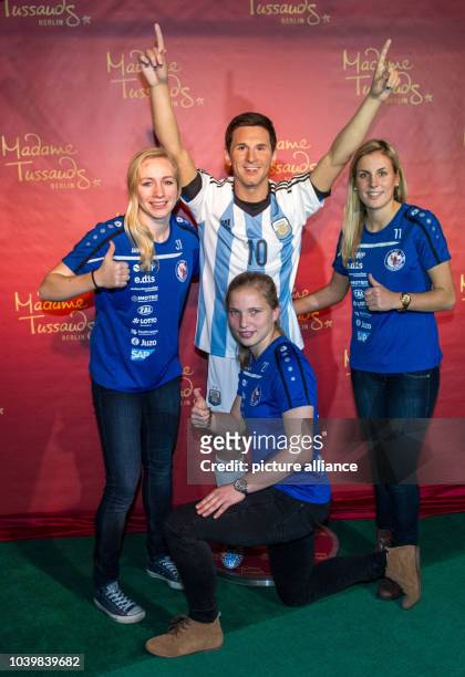 The German women's soccer national team players Pauline Bremer, Tabea Kemme, and Jennifer Cramer pose in front of the wax figure of soccer superstar...