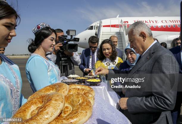 Turkish Parliament Speaker Binali Yildirim and his wife Semiha Yildirim are welcomed at Samarkand International Airport during Binali Yildirim's...