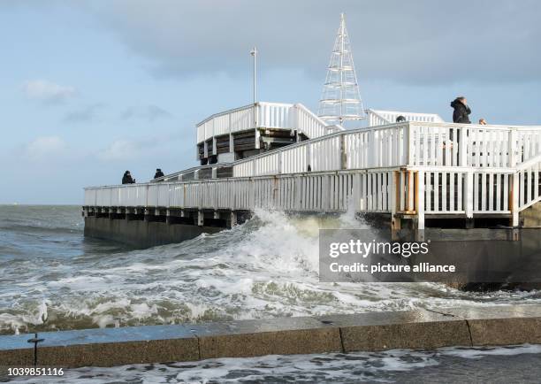 The high water goes over the limit of the bank and floods the area around the 'Alte Liebe' wooden pier in Cuxhaven, Germany, 26 December 2016. The...