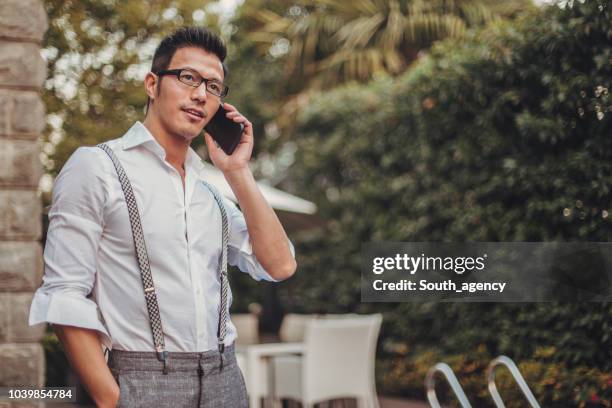 businessman talking on mobile - suspenders stock pictures, royalty-free photos & images
