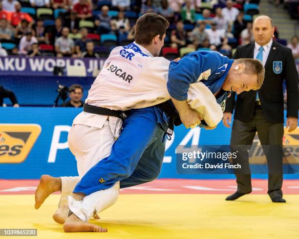 Axel Clerget of France attacks Eduard Trippel of Germany eventually winning the u90kg bronze medal contest by an ippon from a strangle submission...