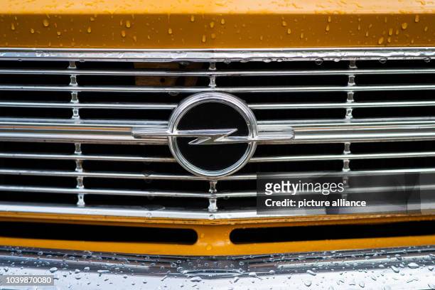 The logo of German automobile manufacturer Opel is pictured on a rain-covered radiator grill of an old 'Ascona 16 S' in Bayreuth, Germany, 16 April...