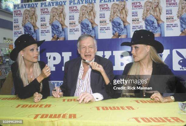 Twins Mandy and Sandy Bentley with Hugh Hefner at a press conference in a Tower Records store in connection with their appearance in Playboy.