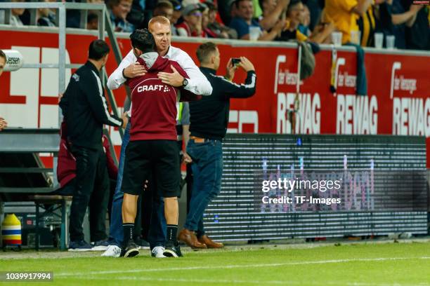 Head coach Maik Walpurgis of Dynamo Dresden and Assistant coach Matthias Lust of Dynamo Dresden celebrate after winning the Second Bundesliga match...