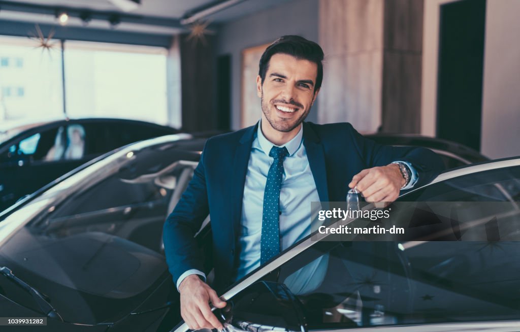 Businessman enjoying new car