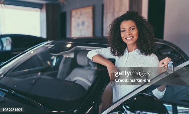 mixed race woman enjoying new car - man and woman and car stock pictures, royalty-free photos & images