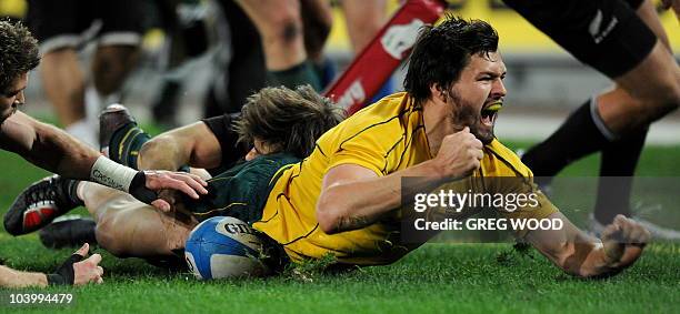 Adam Ashley-Cooper from Australia is jubilant as he scores a try in the final Tri-Nations Test against New Zealand in Sydney on September 11, 2010....