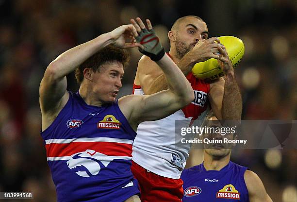 Rhyce Shaw of the Swans marks over the top of Tom Williams of the Bulldogs during the AFL First Semi Final match between the Western Bulldogs and the...