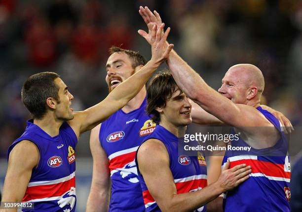Daniel Giansiracusa, Ben Hudson, Ryan Griffen and Barry Hall of the Bulldogs celebrate winning the AFL First Semi Final match between the Western...