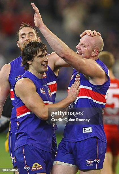 Ben Hudson, Ryan Griffen and Barry Hall of the Bulldogs celebrate winning the AFL First Semi Final match between the Western Bulldogs and the Sydney...