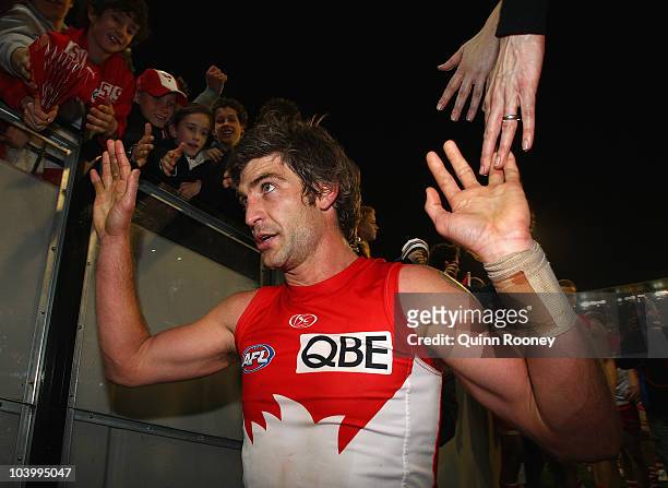 Brett Kirk of the Swans waves good bye to the fans after playing his last game during the AFL First Semi Final match between the Western Bulldogs and...