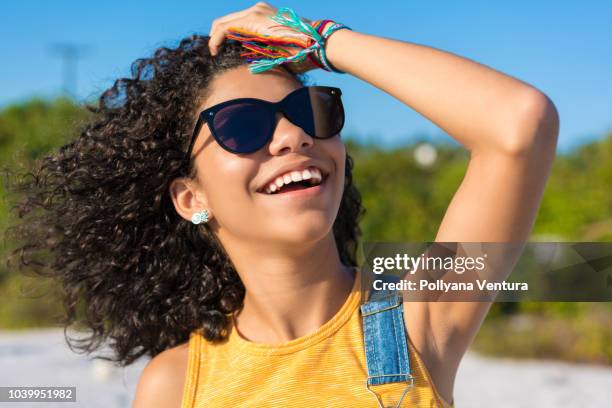 cheerful laughing girl on the beach - summer hair care stock pictures, royalty-free photos & images