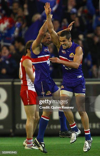 Brad Johnson and Daniel Giansiracusa of the Bulldogs celebrate a goal during the AFL First Semi Final match between the Western Bulldogs and the...