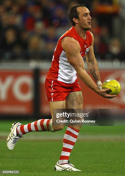 Daniel Bradshaw of the Swans handballs during the AFL First Semi Final match between the Western Bulldogs and the Sydney Swans at Melbourne Cricket...