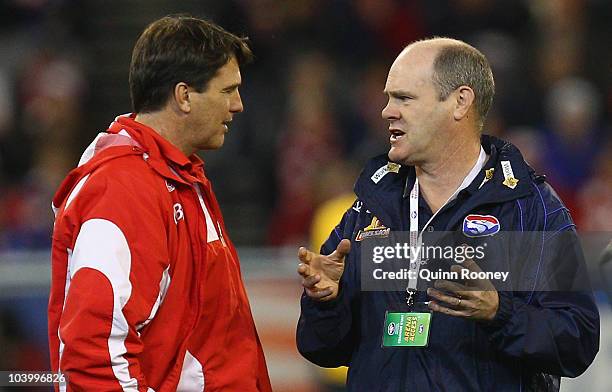 Paul Roos the coach of the Swans and Rodney Eade the coach of the Bulldogs speak before the start of the AFL First Semi Final match between the...