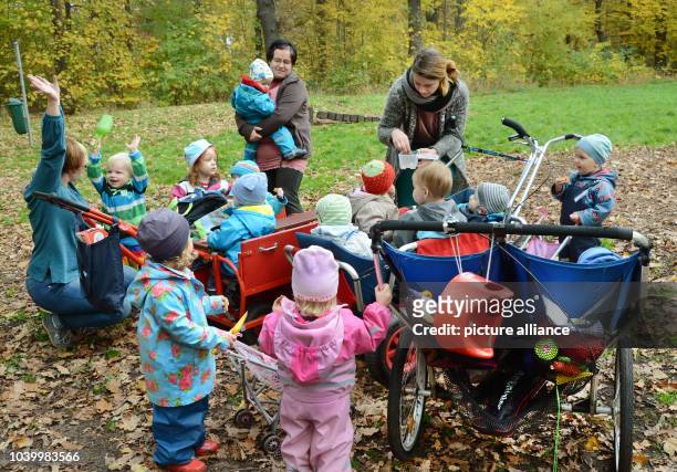 The three childminders Katja Schulte, Melanie Rachow and Sindy Loeser prepare their children in care for their return home in a small local forest in...