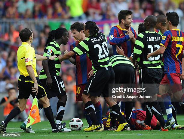 Royston Drenthe of Hercules argues with Lionel Messi of Barcelona during the La Liga match between Barcelona and Hercules at the Camp Nou stadium on...