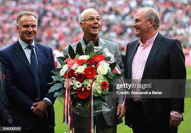German soccer legend Franz Beckenbauer sings as Karl-Heinz Rummenigge and the president of Bayern Muenchen Uli Hoeness smile before the Bundesliga...