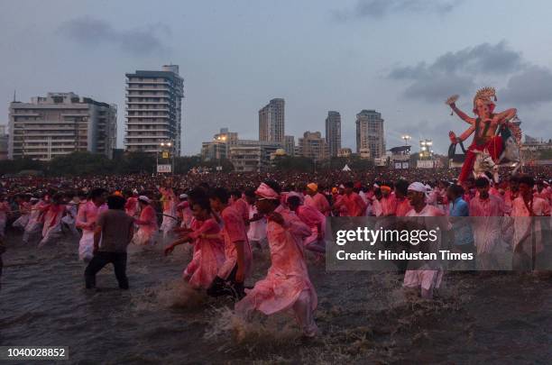 Devotees prepare to immerse idols of elephant-headed Hindu God Ganesha in the Arabian Sea, marking the end of the 10-day long Ganesh Chaturthi...