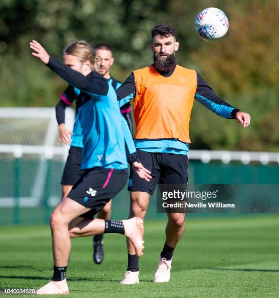 Mile Jedinak of Aston Villa in action during a training session at the club's training ground at Bodymoor Heath on September 25, 2018 in Birmingham,...