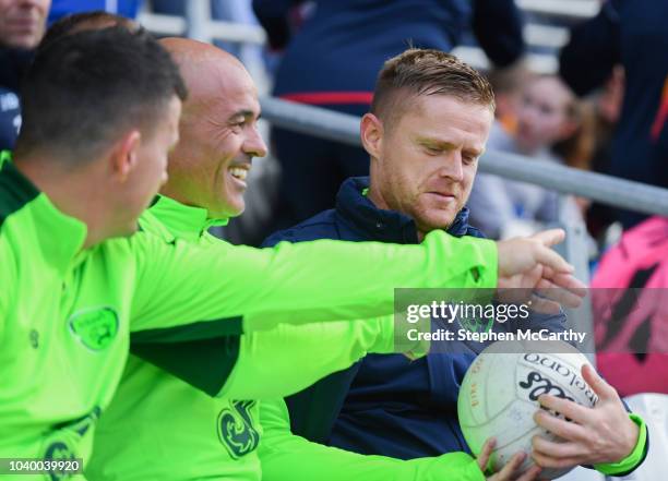 Cork , Ireland - 25 September 2018; Damien Duff of Republic of Ireland & Celtic Legends signs his autograph on a GAA ball during the Liam Miller...