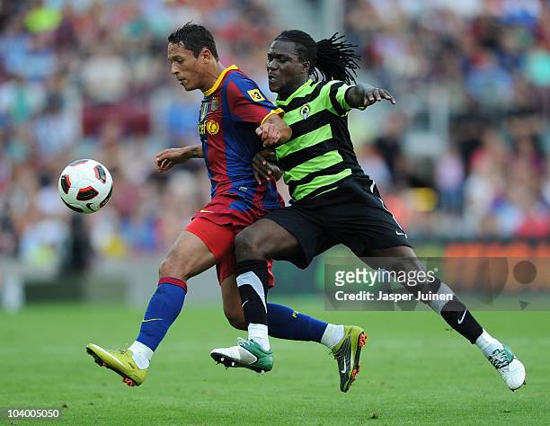 Adriano of Barcelona duels for the ball with Royston Drenthe of Hercules during the La Liga match between Barcelona and Hercules at the Camp Nou...