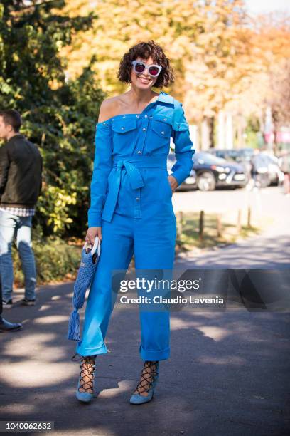 Guest, wearing light blue jumpsuit and sunglasses, is seen after the Jour/ne show on September 25, 2018 in Paris, France.