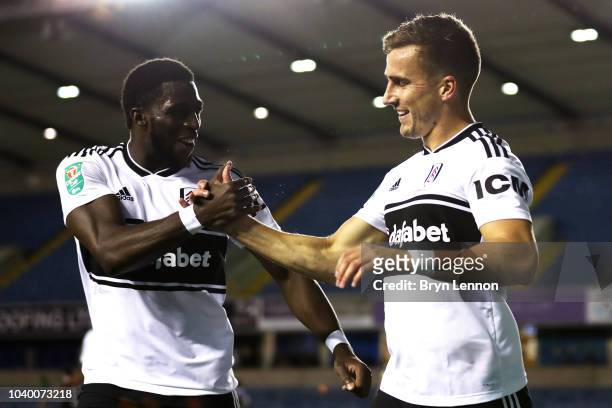 Joe Bryan of Fulham celebrates with teammate Aboubakar Kamara after scoring his team's first goal during the Carabao Cup Third Round match between...