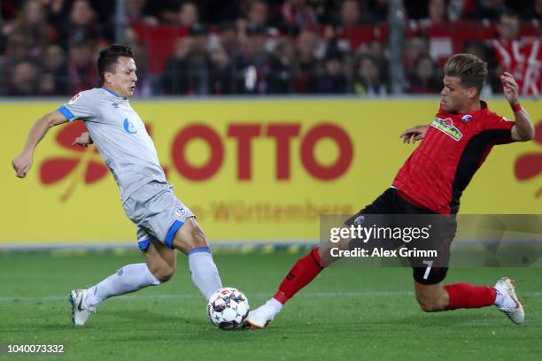 Florian Niederlechner of Freiburg is challanaged by Yevhen Konoplyanka of FC Schalke 04 during the Bundesliga match between Sport-Club Freiburg and...