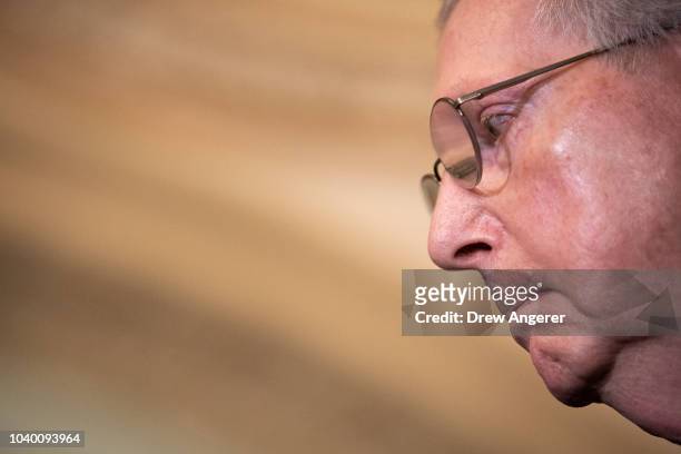 Senate Majority Leader Mitch McConnell pauses while speaking to reporters following the weekly GOP policy luncheon on Capitol Hill, September 25,...