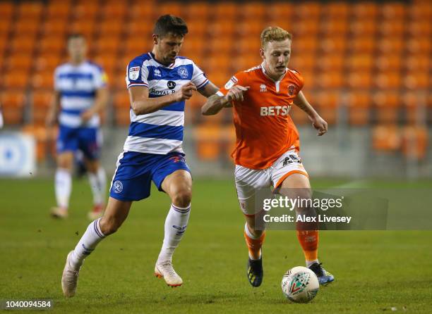 Callum Guy of Blackpool holds off a challenge from Pawel Wszolek of Queens Park Rangers during the Carabao Cup Third Round match between Blackpool...